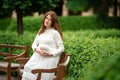 Pregnant woman holding a letter from plastic