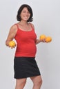 Pregnant woman holding a orange fruit on white background Royalty Free Stock Photo
