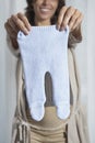 Pregnant Woman Holding Out Baby Pants Royalty Free Stock Photo