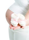 Pregnant woman holding pair of pink bootee Royalty Free Stock Photo