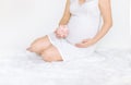 A pregnant woman is holding a piggy bank. Selective focus Royalty Free Stock Photo