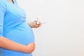 Pregnant woman holding plane model