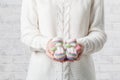 Pregnant woman is holding small shoes for the unborn baby Royalty Free Stock Photo