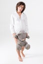 Pregnant woman holding soft toy. Pretty young woman carrying teddy bear.