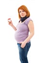 Pregnant woman holding some pills