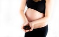 Pregnant woman holding tea leaves in her hands. Healthy eating diet lifestyle concept