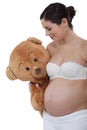 Pregnant woman holding teddy bear
