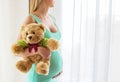 Pregnant woman holding teddy bear Royalty Free Stock Photo