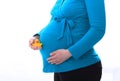 Pregnant woman holding toy in hand