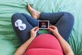 Pregnant woman holding ultrasound image. Royalty Free Stock Photo