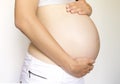 Pregnant woman holds belly