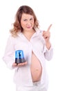 Pregnant woman holds blue flasher and raises index finger