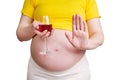 A pregnant woman holds a glass of red wine in her hand and shows a Royalty Free Stock Photo