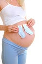 The pregnant woman holds little socks