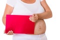 Pregnant woman holds sign at the camera