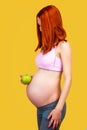 Pregnant woman holing green apple Royalty Free Stock Photo