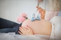 Pregnant woman holding blue baby booties Royalty Free Stock Photo