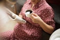 Pregnant woman at home reading book and holding cup of coffee Royalty Free Stock Photo