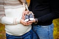 Pregnant woman hugging her husband and they keep booties for unborn child Royalty Free Stock Photo