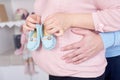 Pregnant woman hugging her husband and they keep booties for unborn child Royalty Free Stock Photo