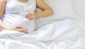 A pregnant woman hugs her belly with a toy. Selective focus Royalty Free Stock Photo