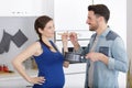 Pregnant woman and husband cooking healthy in kitchen Royalty Free Stock Photo