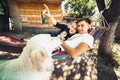 Pregnant woman and husband, resting in a hammock