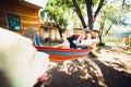 Pregnant woman and husband, resting in a hammock