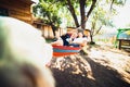 Pregnant woman and husband, resting in a hammock