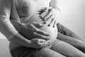 Pregnant woman with husband sitting on floor Royalty Free Stock Photo