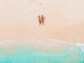 Pregnant woman with husband at tropical beach with blue sea. Aerial view Royalty Free Stock Photo