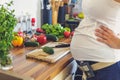 Pregnant woman with insuline pump preparing healthy food