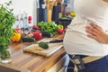 Pregnant woman with insuline pump preparing healthy food Royalty Free Stock Photo