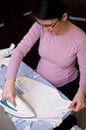 Pregnant woman ironing