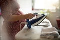 Pregnant woman ironing baby laundry at home Royalty Free Stock Photo