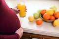 Healthy nutrition and diet during pregnancy. Cute young pregnant woman with glass of fresh juice