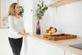 Pregnant woman in kitchen making salad Royalty Free Stock Photo