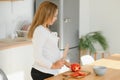 Pregnant woman in kitchen making salad Royalty Free Stock Photo