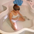 Pregnant woman kneeling in birthing pool Royalty Free Stock Photo