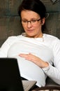 Pregnant woman with laptop in bed Royalty Free Stock Photo