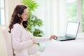 Pregnant woman laptop. Pregnancy online shopping Royalty Free Stock Photo