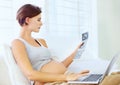 Pregnant woman, laptop and ultrasound image in home with relax wellness and excited on prenatal care in bedroom. Person Royalty Free Stock Photo