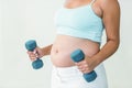 Pregnant woman lifting dumbbells Royalty Free Stock Photo