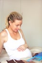 Pregnant woman looking at baby books Royalty Free Stock Photo