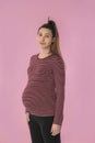 Pregnant woman looking focused holding her belly Royalty Free Stock Photo