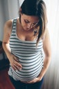 Pregnant woman looking her belly Royalty Free Stock Photo