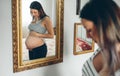 Pregnant woman looking her belly Royalty Free Stock Photo