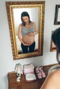 Pregnant woman looking her belly Royalty Free Stock Photo