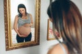 Pregnant woman looking her belly Royalty Free Stock Photo