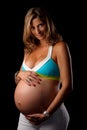 Pregnant woman looking and holding her belly Royalty Free Stock Photo